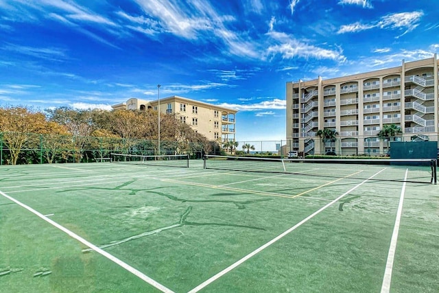 view of tennis court with fence