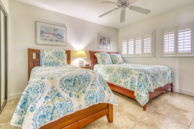 bedroom with tile patterned floors, ceiling fan, and baseboards