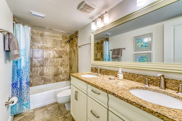 bathroom featuring a sink, visible vents, and toilet