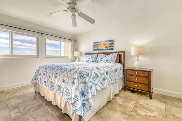 bedroom featuring tile patterned floors, baseboards, and a ceiling fan