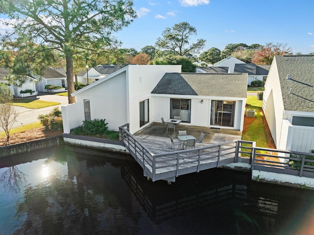 back of property with a wooden deck, central AC, and a shingled roof