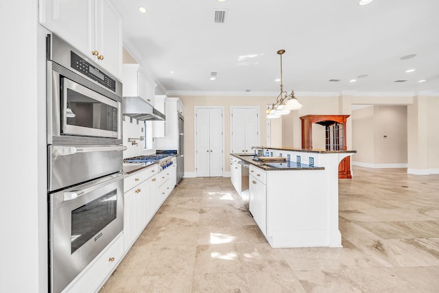 kitchen featuring white cabinets, stainless steel appliances, crown molding, and baseboards