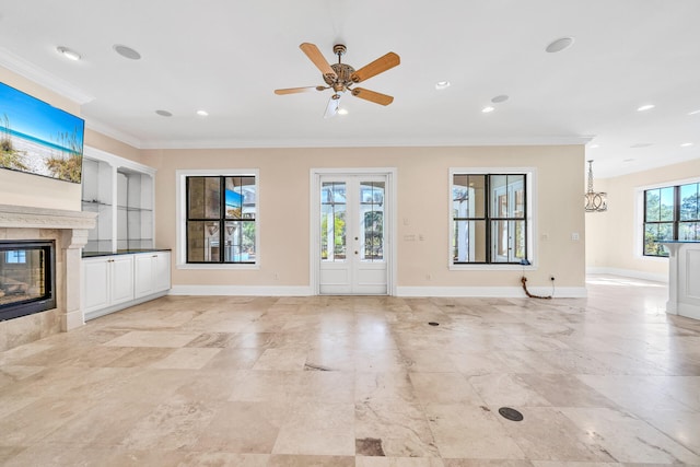 unfurnished living room featuring a premium fireplace, recessed lighting, baseboards, and ornamental molding