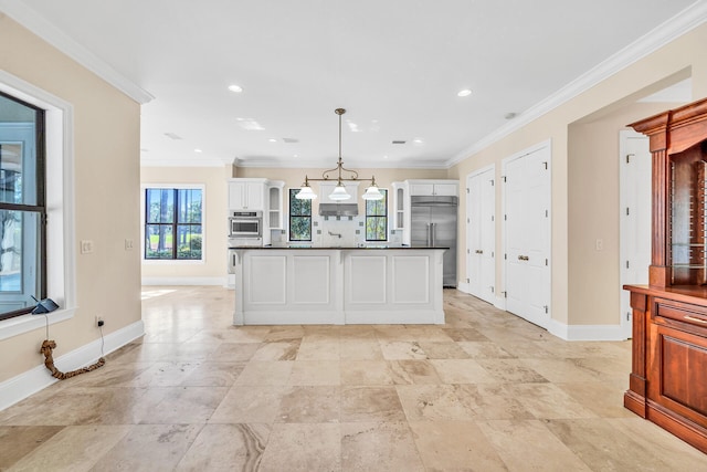 kitchen featuring dark countertops, white cabinets, pendant lighting, and stainless steel built in fridge