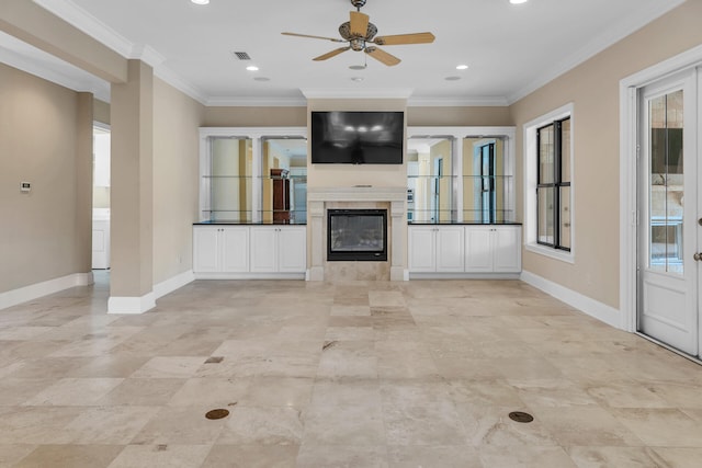 unfurnished living room with a tiled fireplace, visible vents, baseboards, and ornamental molding