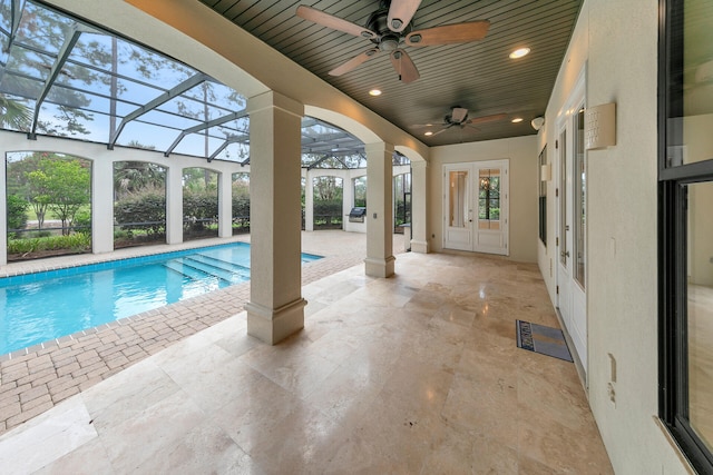 outdoor pool with ceiling fan, french doors, glass enclosure, and a patio