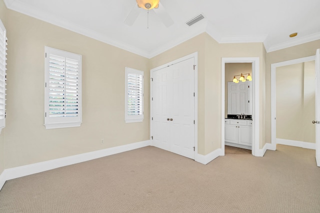 unfurnished bedroom featuring ornamental molding, baseboards, visible vents, and light carpet