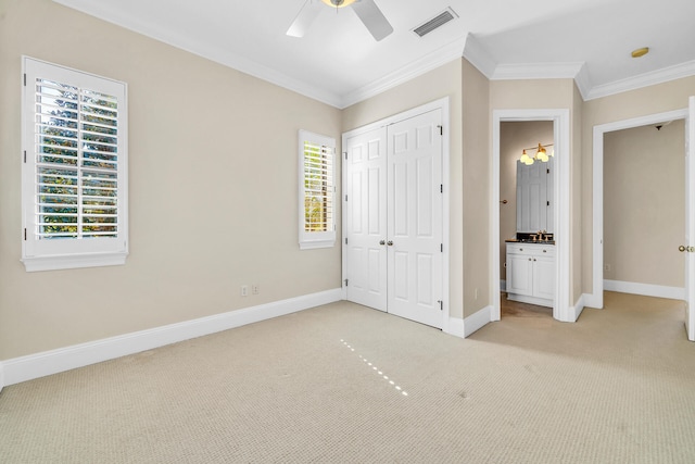 unfurnished bedroom with visible vents, light carpet, baseboards, and ornamental molding