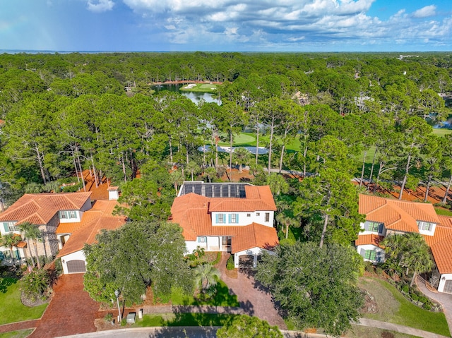 bird's eye view with a forest view and a water view