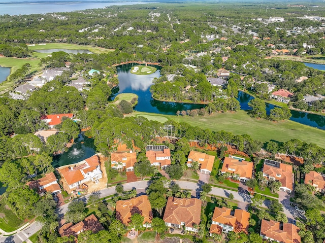 aerial view with view of golf course, a water view, and a residential view