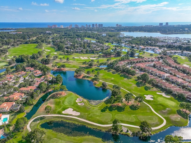 drone / aerial view featuring view of golf course and a water view