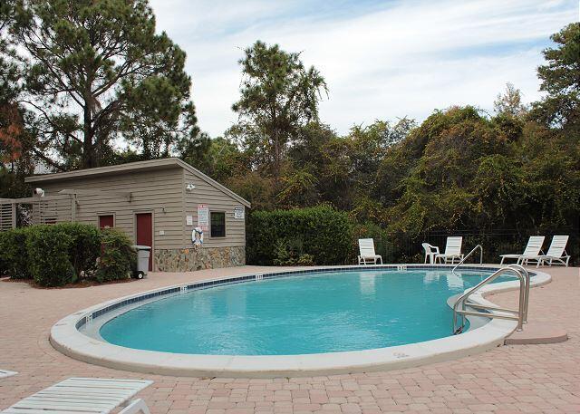 pool with a patio and fence