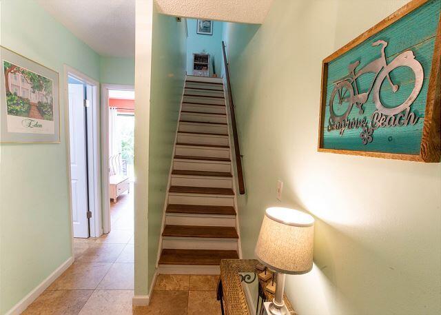 staircase featuring tile patterned flooring and baseboards