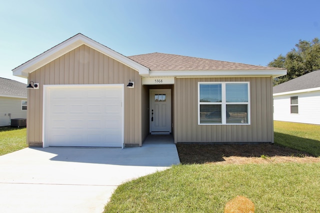 view of front of home with an attached garage, a front lawn, roof with shingles, central AC unit, and driveway