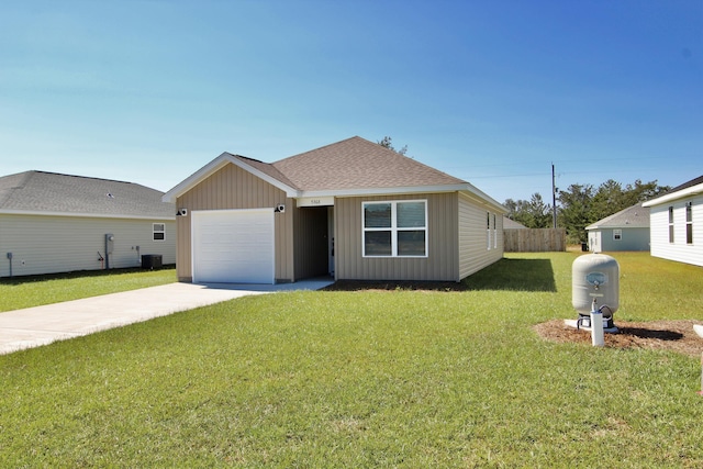 view of front of property with an attached garage, driveway, a front yard, and roof with shingles