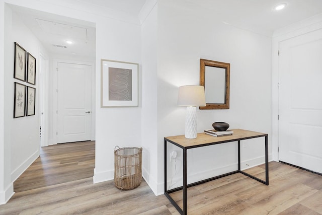 hall featuring recessed lighting, baseboards, light wood-style floors, and ornamental molding