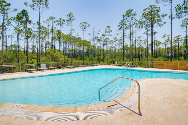 pool featuring a patio and fence