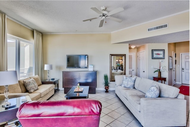 living room featuring visible vents, ornamental molding, a ceiling fan, a textured ceiling, and light tile patterned floors