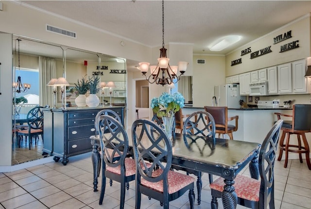 dining room with crown molding, light tile patterned floors, visible vents, and a chandelier