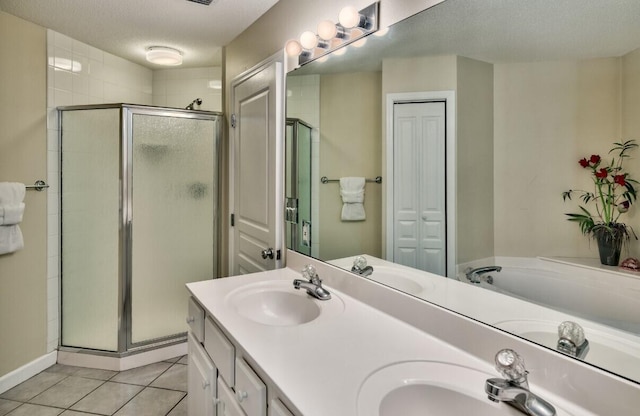 full bath featuring tile patterned flooring, a stall shower, and a sink