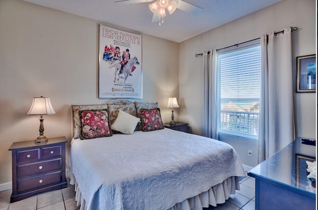 bedroom with light tile patterned floors, baseboards, and ceiling fan