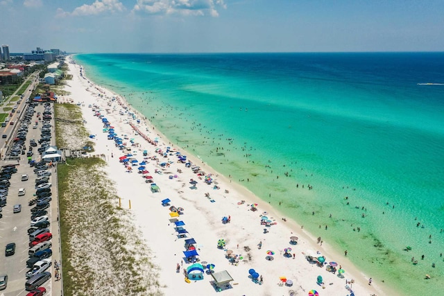 drone / aerial view with a water view and a view of the beach