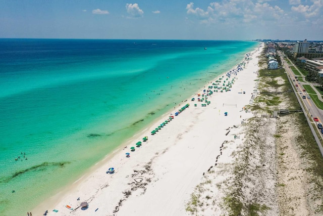 drone / aerial view featuring a beach view and a water view