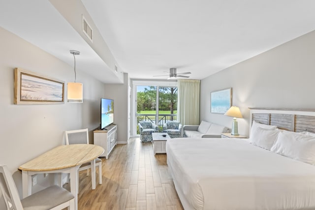 bedroom with light wood finished floors, visible vents, baseboards, a ceiling fan, and access to outside