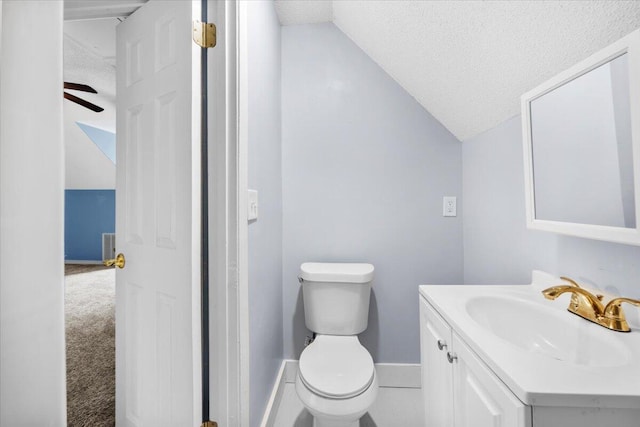 half bath featuring toilet, lofted ceiling, a textured ceiling, baseboards, and vanity