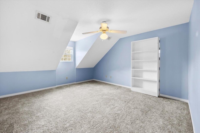 bonus room with a ceiling fan, carpet, visible vents, baseboards, and lofted ceiling