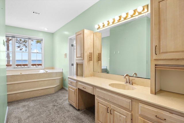 bathroom with a bath, visible vents, vanity, and carpet