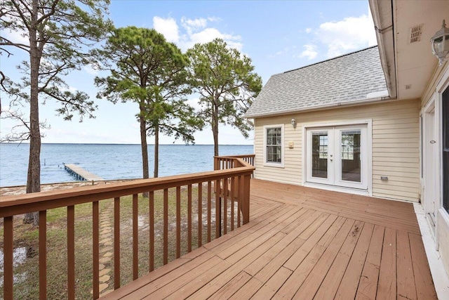 wooden terrace with french doors and a water view