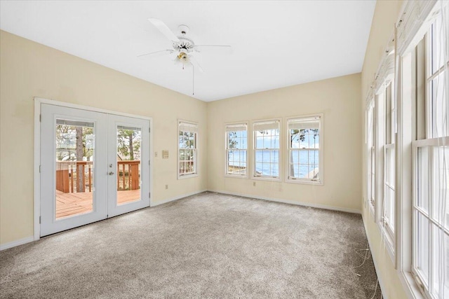 empty room featuring french doors, baseboards, a ceiling fan, and carpet floors