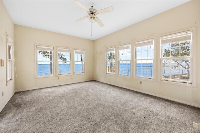 unfurnished room featuring baseboards, a ceiling fan, and carpet flooring