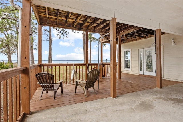 wooden terrace featuring french doors and a water view