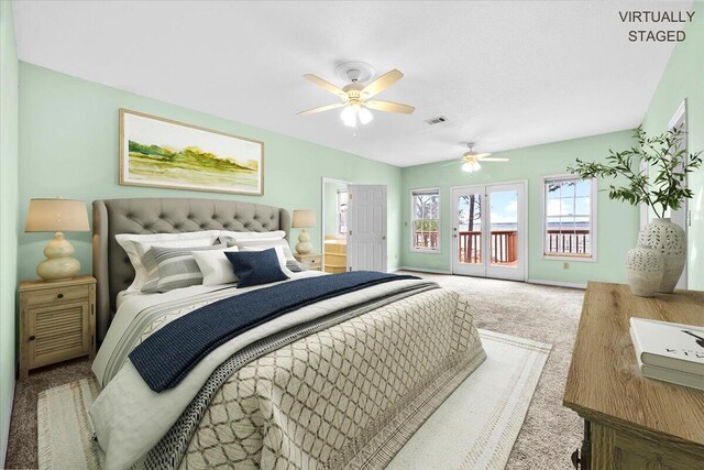 carpeted bedroom featuring visible vents, baseboards, a ceiling fan, and access to outside