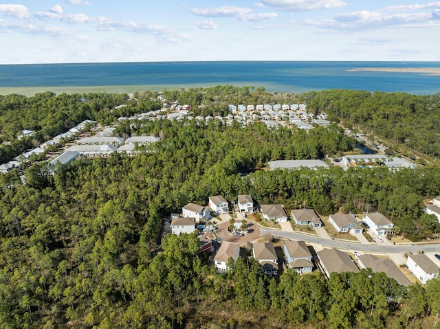 birds eye view of property featuring a residential view, a forest view, and a water view