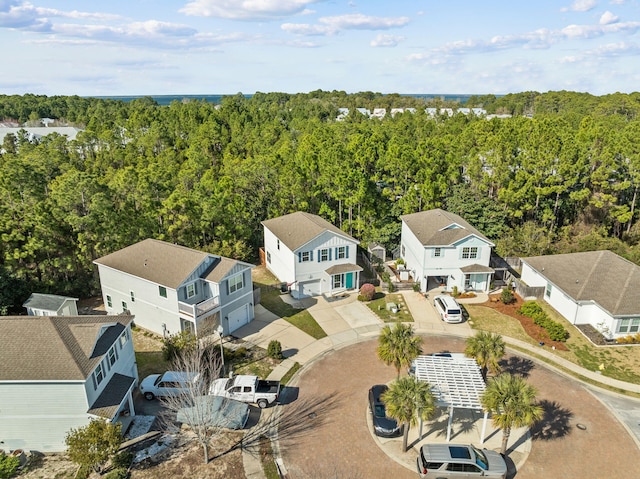 birds eye view of property with a residential view and a wooded view