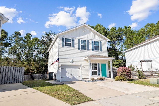 view of front facade featuring board and batten siding, concrete driveway, an attached garage, and fence