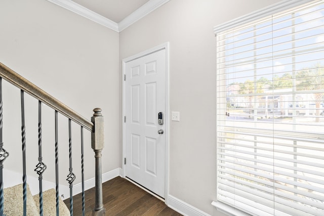 entrance foyer featuring dark wood-style floors, stairway, baseboards, and ornamental molding