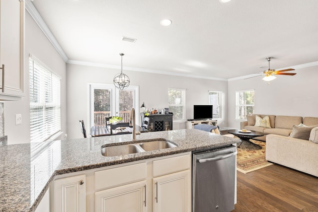 kitchen with dark wood-type flooring, ornamental molding, a sink, plenty of natural light, and stainless steel dishwasher