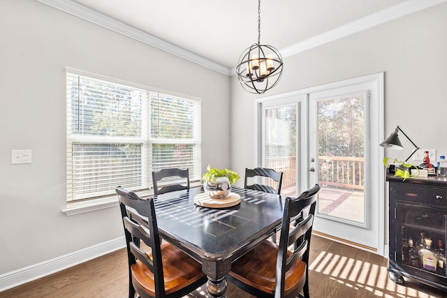 dining area with baseboards, a chandelier, ornamental molding, french doors, and wood finished floors