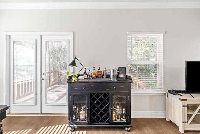 interior space featuring crown molding, wood finished floors, and baseboards