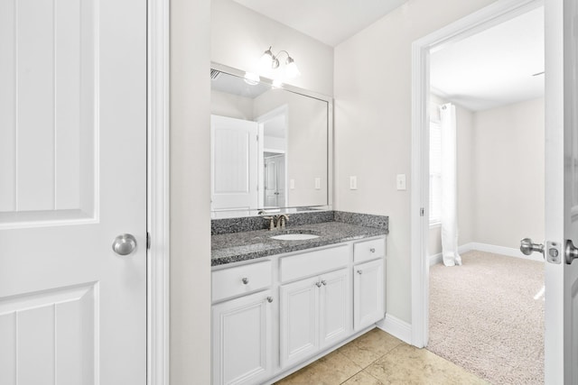 bathroom with tile patterned flooring, vanity, and baseboards