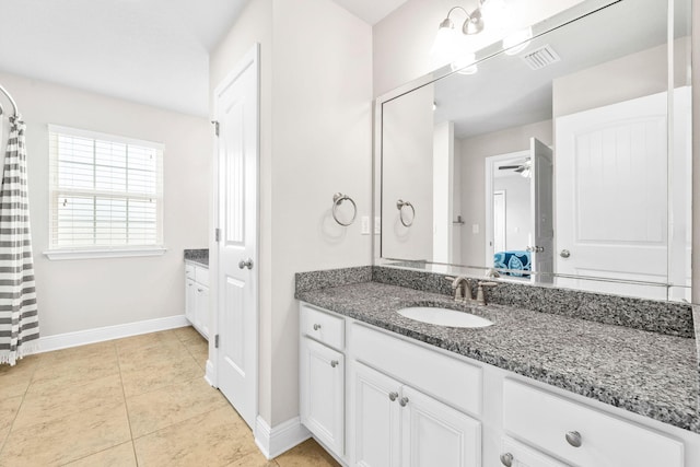 bathroom with visible vents, vanity, and baseboards