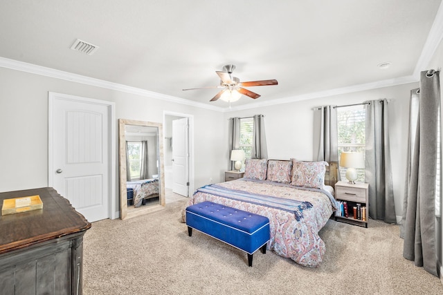 carpeted bedroom with visible vents, crown molding, and ceiling fan