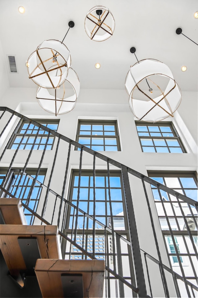 room details featuring a chandelier, visible vents, and recessed lighting