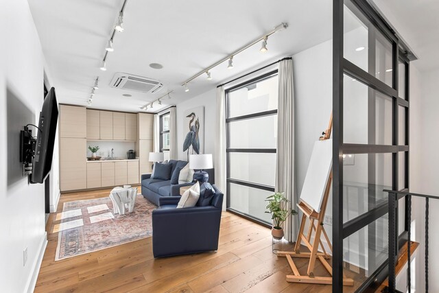 interior space with light wood-style flooring and rail lighting