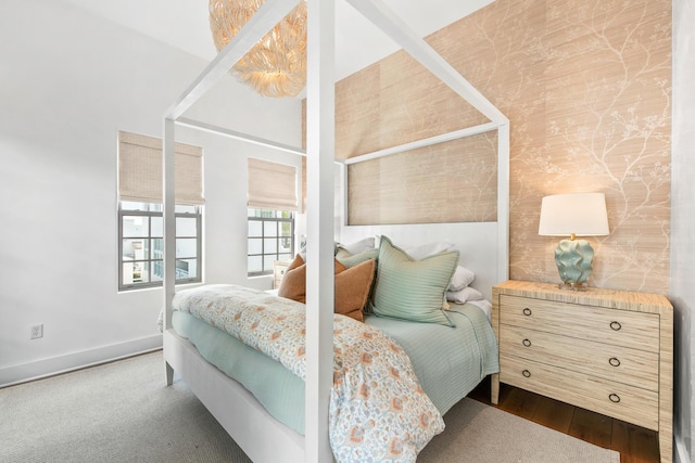 bedroom with baseboards and dark wood finished floors