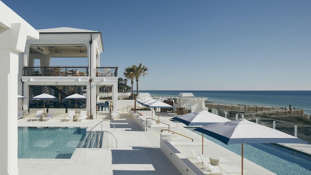 pool with a gazebo, a patio, and a water view